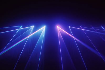 Laser lighting beams across a stage